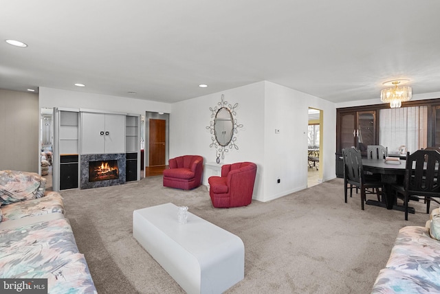 living area with a high end fireplace, carpet floors, baseboards, and recessed lighting