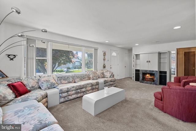 living room with a lit fireplace, carpet flooring, and recessed lighting