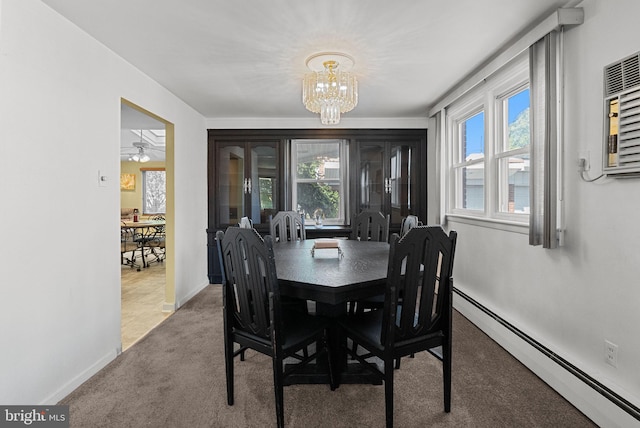 dining area with carpet floors, a chandelier, baseboards, and a baseboard heating unit