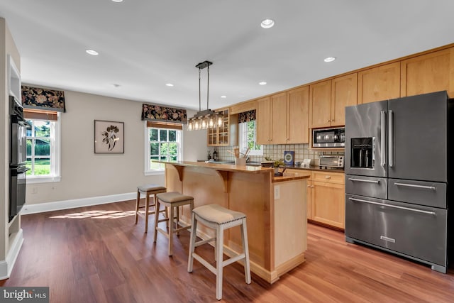 302 Maple Ln, Severna Park, MD 21146 - kitchen with high end fridge, built in microwave, wood finished floors, light brown cabinets, and recessed lighting