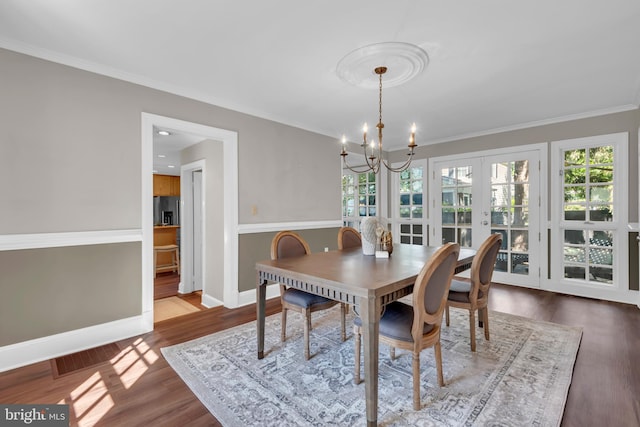 302 Maple Ln, Severna Park, MD 21146 - dining room with a chandelier, wood finished floors, baseboards, french doors, and crown molding