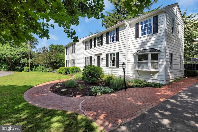 302 Maple Ln, Severna Park, MD 21146 - colonial house featuring a front yard and a chimney