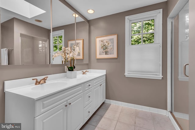 302 Maple Ln, Severna Park, MD 21146 - full bath with double vanity, plenty of natural light, a skylight, and baseboards