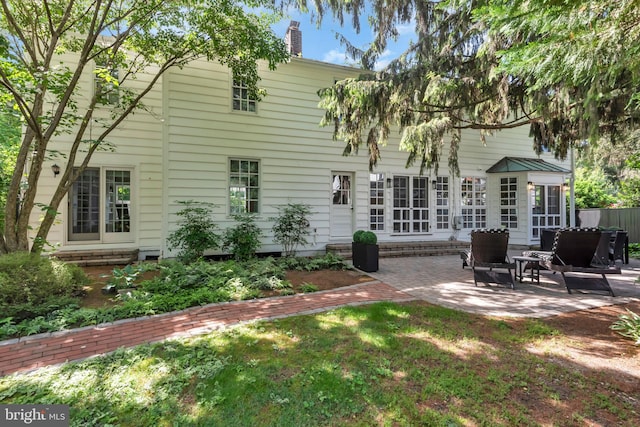 302 Maple Ln, Severna Park, MD 21146 - rear view of house featuring a patio, a chimney, and a yard