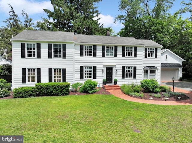 302 Maple Ln, Severna Park, MD 21146 - colonial-style house with a chimney, a front yard, an outbuilding, and a garage
