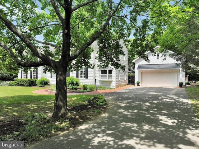 302 Maple Ln, Severna Park, MD 21146 - view of property hidden behind natural elements with driveway, an outbuilding, a front yard, and an attached garage