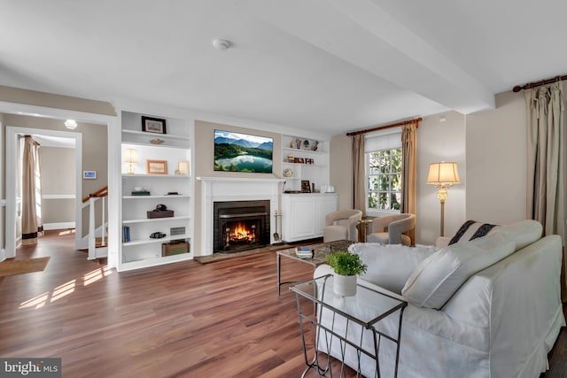 302 Maple Ln, Severna Park, MD 21146 - living room featuring wood finished floors, built in features, a fireplace, and baseboards