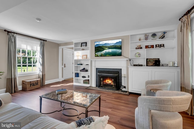 302 Maple Ln, Severna Park, MD 21146 - living room featuring a fireplace, wood finished floors, baseboards, and built in features