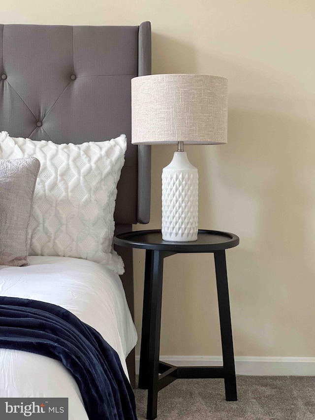 bedroom featuring carpet floors and baseboards