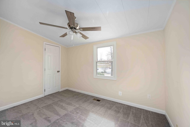 unfurnished room with ceiling fan, visible vents, carpet floors, baseboards, and ornamental molding