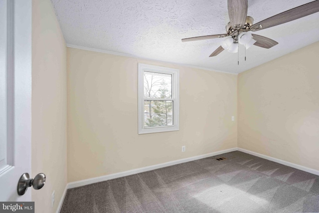 carpeted spare room featuring baseboards, ceiling fan, a textured ceiling, and visible vents