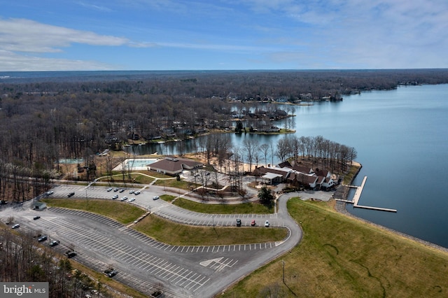 drone / aerial view featuring a water view and a wooded view