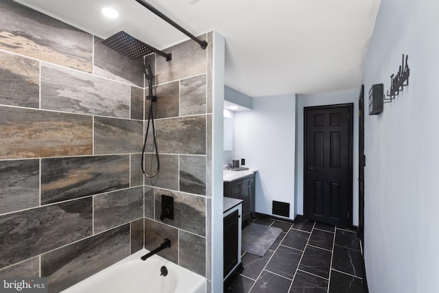 full bathroom with vanity, marble finish floor, and shower / bath combination