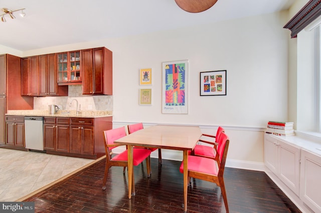 dining room featuring baseboards and light wood finished floors