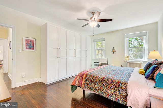 bedroom featuring baseboards, ceiling fan, and dark wood-style floors