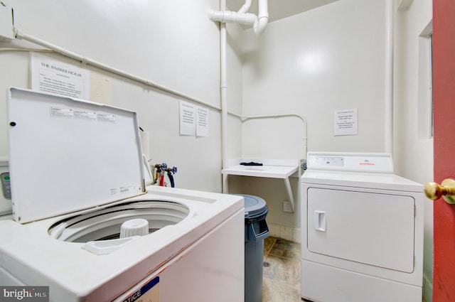 clothes washing area featuring washer and dryer and laundry area