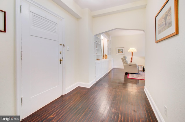 entryway featuring baseboards and hardwood / wood-style flooring