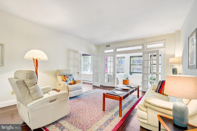 living room with baseboards, french doors, wood finished floors, and visible vents
