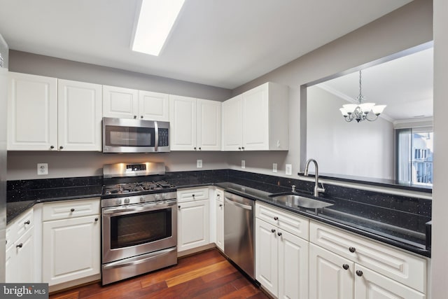 20583 Snowshoe Sq Unit 301, Ashburn, VA 20147 - kitchen with stainless steel appliances, a sink, a chandelier, white cabinets, and dark wood-style floors