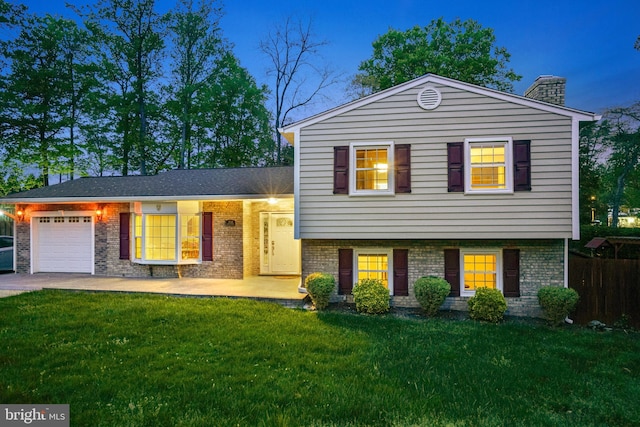 8610 Westmeath Ct, Springfield, VA 22152 - tri-level home with brick siding, a garage, and a front yard
