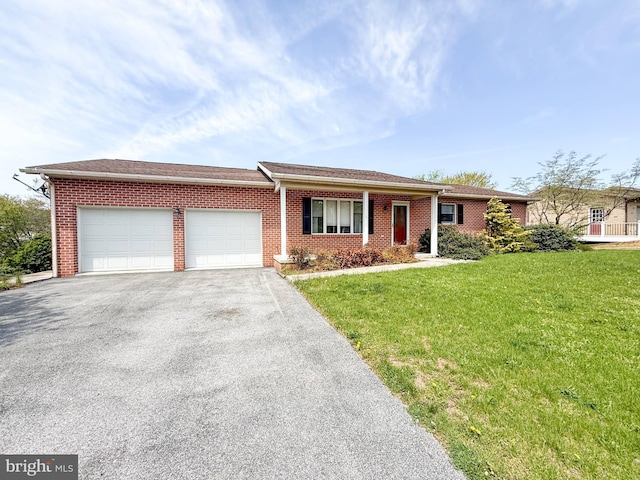 ranch-style home with brick siding, an attached garage, a front lawn, and aphalt driveway