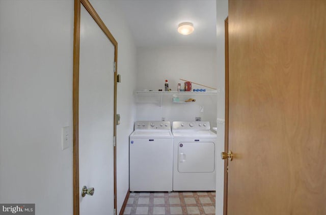 laundry room featuring separate washer and dryer, laundry area, and light floors