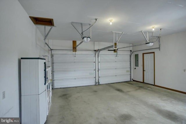 garage with baseboards, a garage door opener, and electric panel