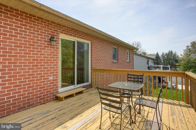 wooden deck featuring outdoor dining space