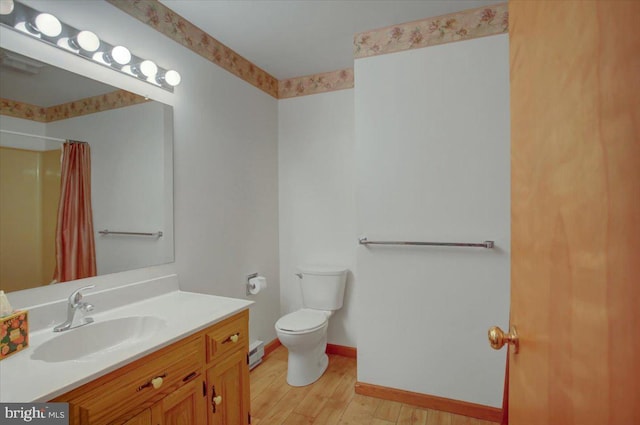 full bath with baseboard heating, vanity, toilet, a shower with shower curtain, and wood finished floors