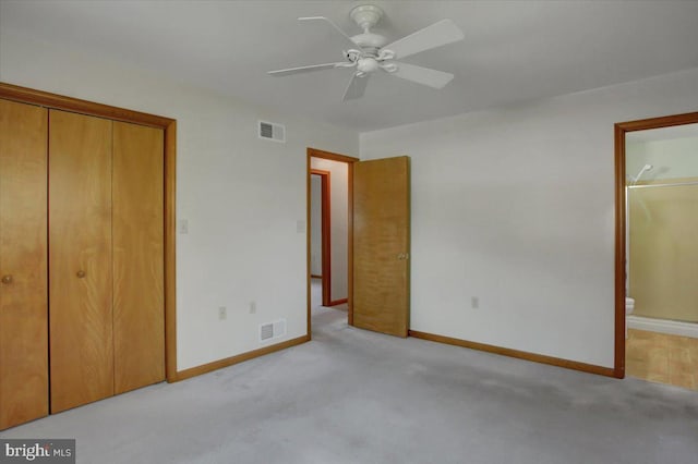 unfurnished bedroom with carpet floors, baseboards, ensuite bathroom, and visible vents