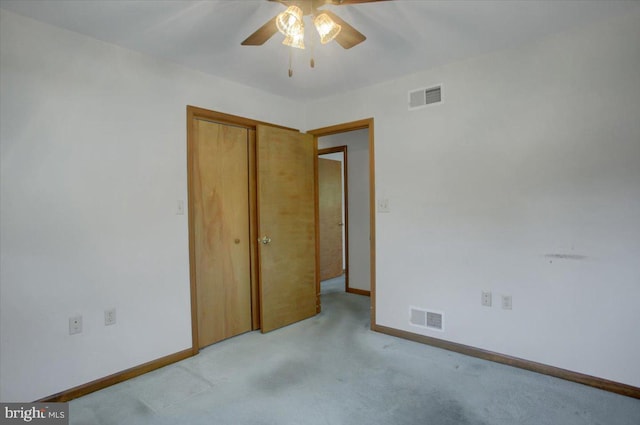 unfurnished bedroom featuring baseboards, visible vents, light carpet, and a closet