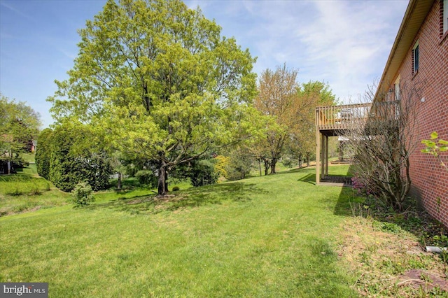 view of yard featuring a wooden deck
