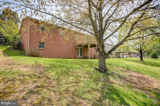 exterior space with a yard and brick siding