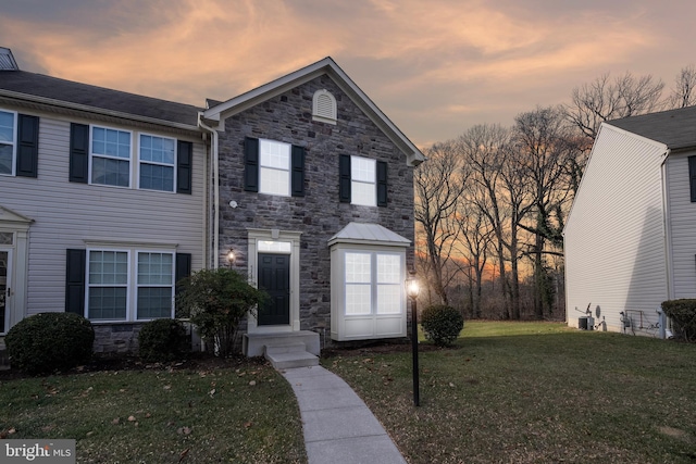 view of front of property featuring a front yard and stone siding