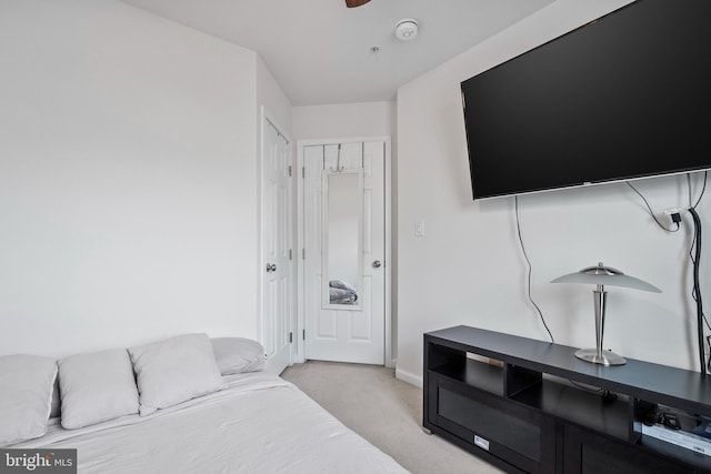bedroom featuring baseboards and light carpet