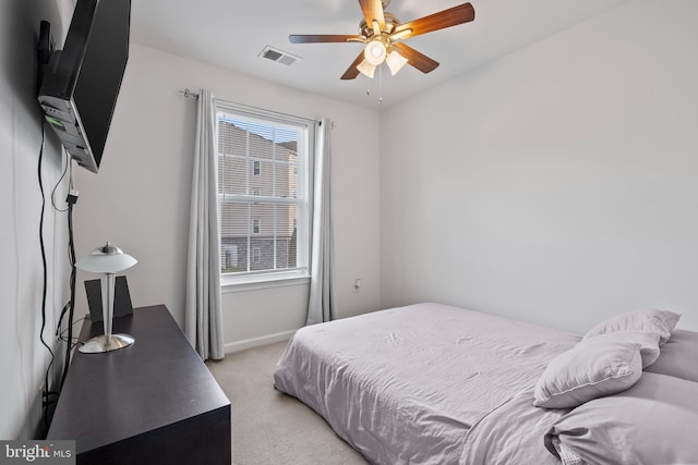 bedroom featuring visible vents, baseboards, multiple windows, and light colored carpet