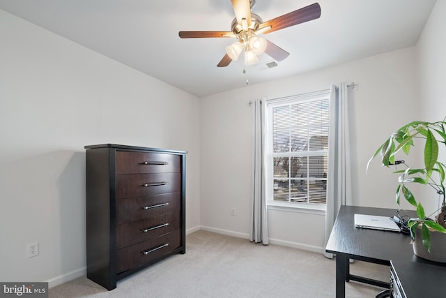 interior space with baseboards, light carpet, a ceiling fan, and visible vents