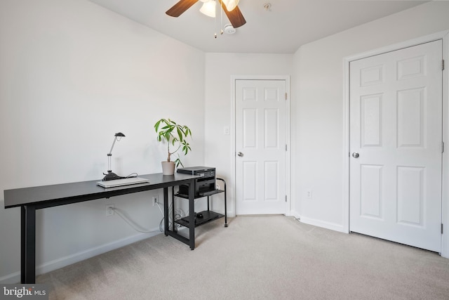 office with baseboards, ceiling fan, and light carpet