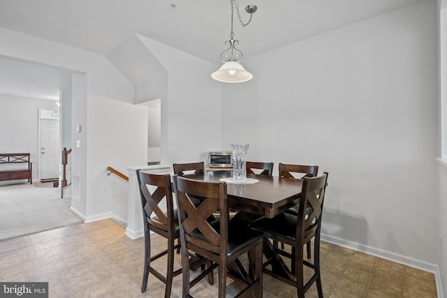 dining area with a toaster and baseboards