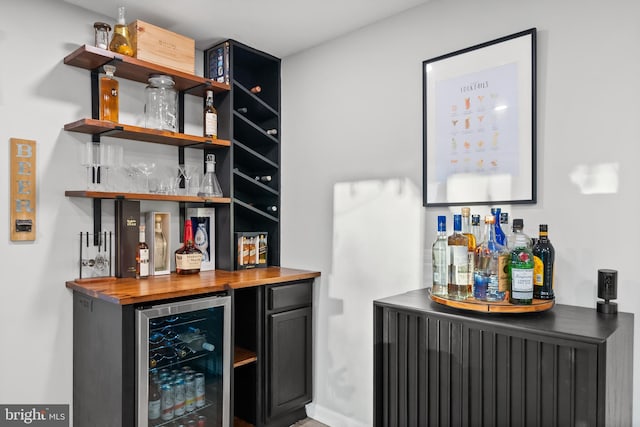 bar with wine cooler and a dry bar