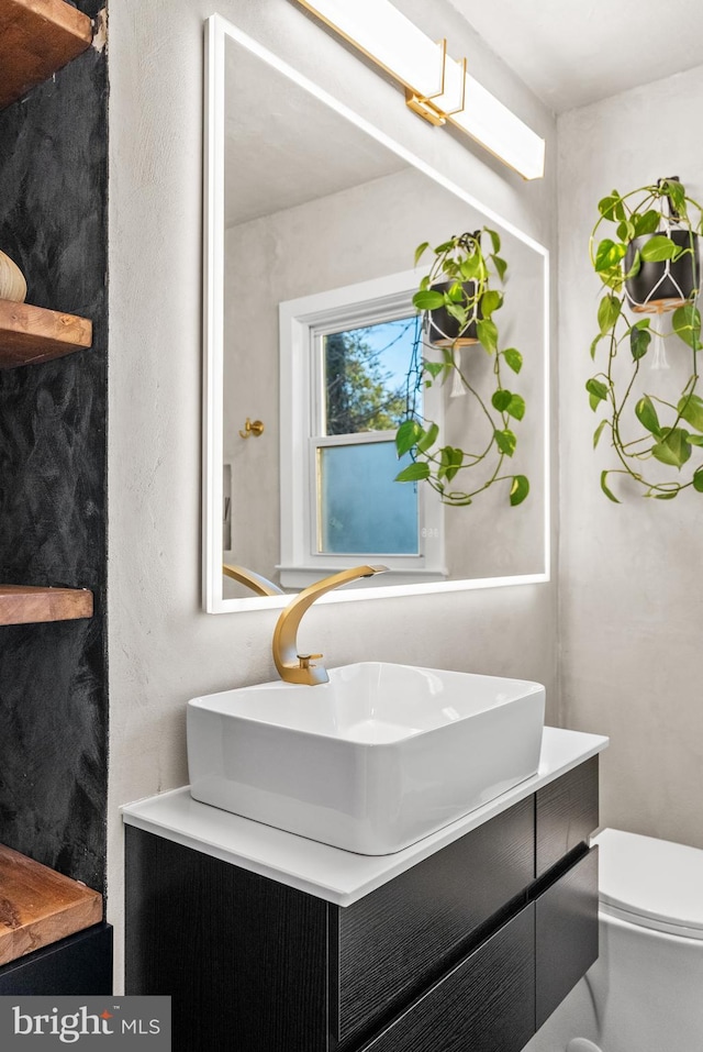 bathroom featuring toilet and vanity