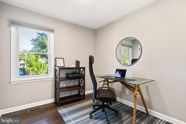 office featuring baseboards, wood finished floors, and visible vents