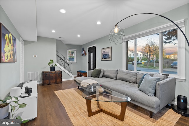 living room with visible vents, dark wood-style flooring, recessed lighting, and stairs