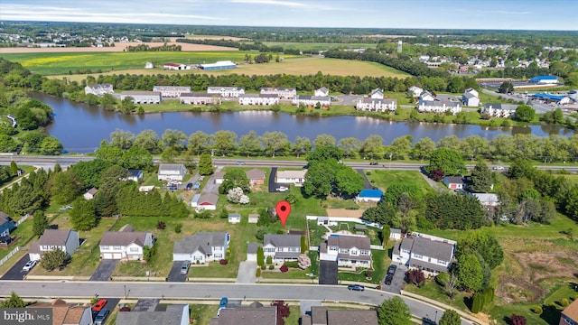 drone / aerial view with a residential view and a water view