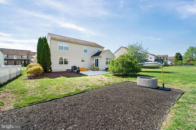 back of property featuring a lawn, a patio area, fence, and a residential view