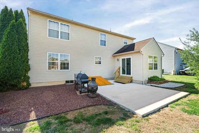 rear view of house featuring a patio area and entry steps