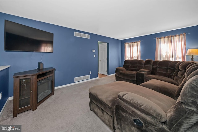 living room featuring visible vents, carpet, and baseboards