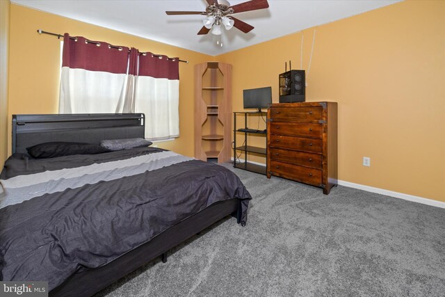 carpeted bedroom featuring baseboards and a ceiling fan