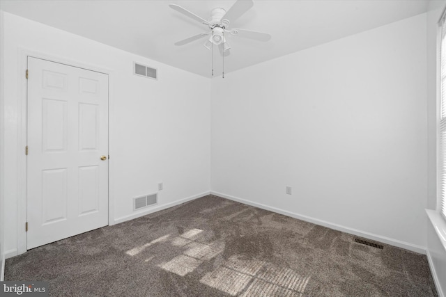carpeted spare room featuring baseboards, a ceiling fan, and visible vents