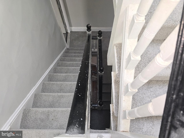 stairway featuring baseboards